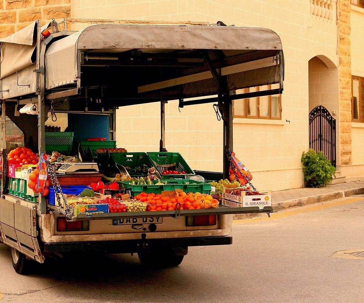 Crates overflowing with fresh berries and grapes